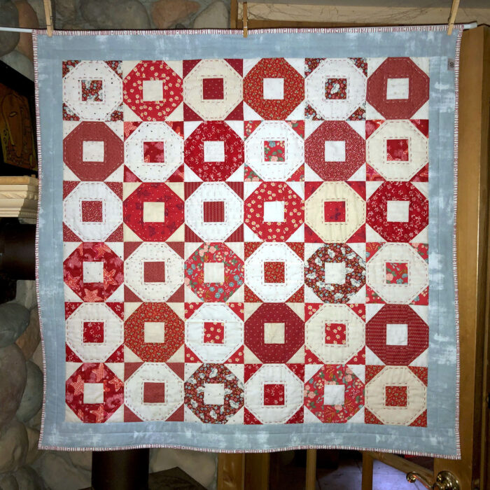 Scrappy Red Alternating Ring Toss Baby Quilt Front