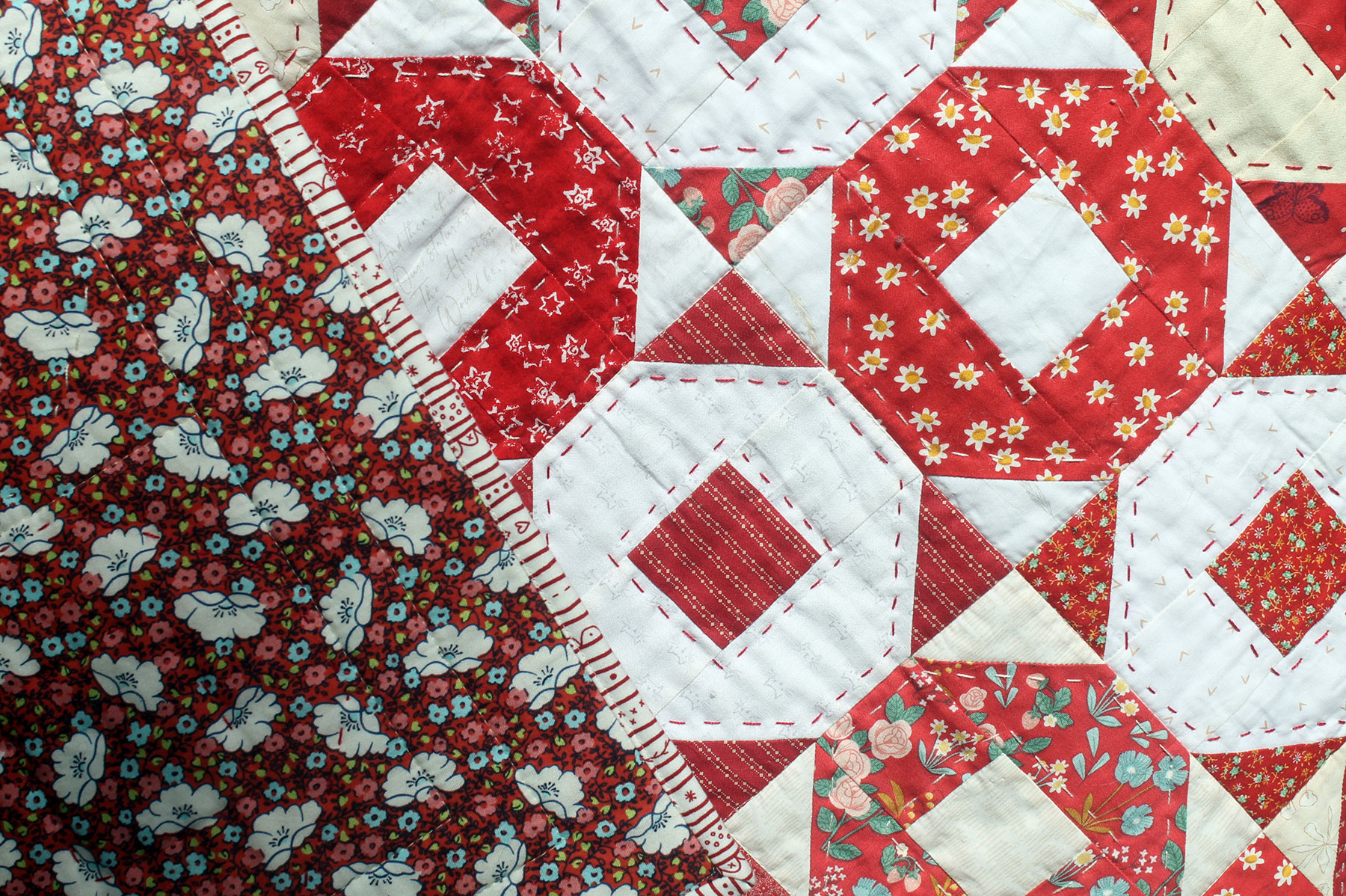 Scrappy Red Alternating Ring Toss Baby Quilt Closeup